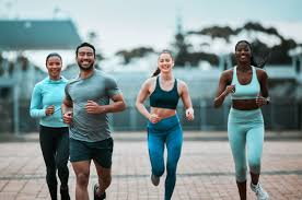 Sculpting Sleek Arms: The Essential Role of Cardio in Toning Without Bulking Up 3 image of people running to incorporate cardio Twickenham exercise into their life to help tone arms and body.