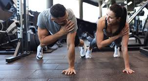 Sculpting Sleek Arms: The Essential Role of Cardio in Toning Without Bulking Up 1 Image of man and woman doing Cardio Twickenham to tone their arms.